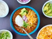 Lots of crunchy, sharp and creamy toppings turn a simple bowl of beef and chili into dinner in an instant.