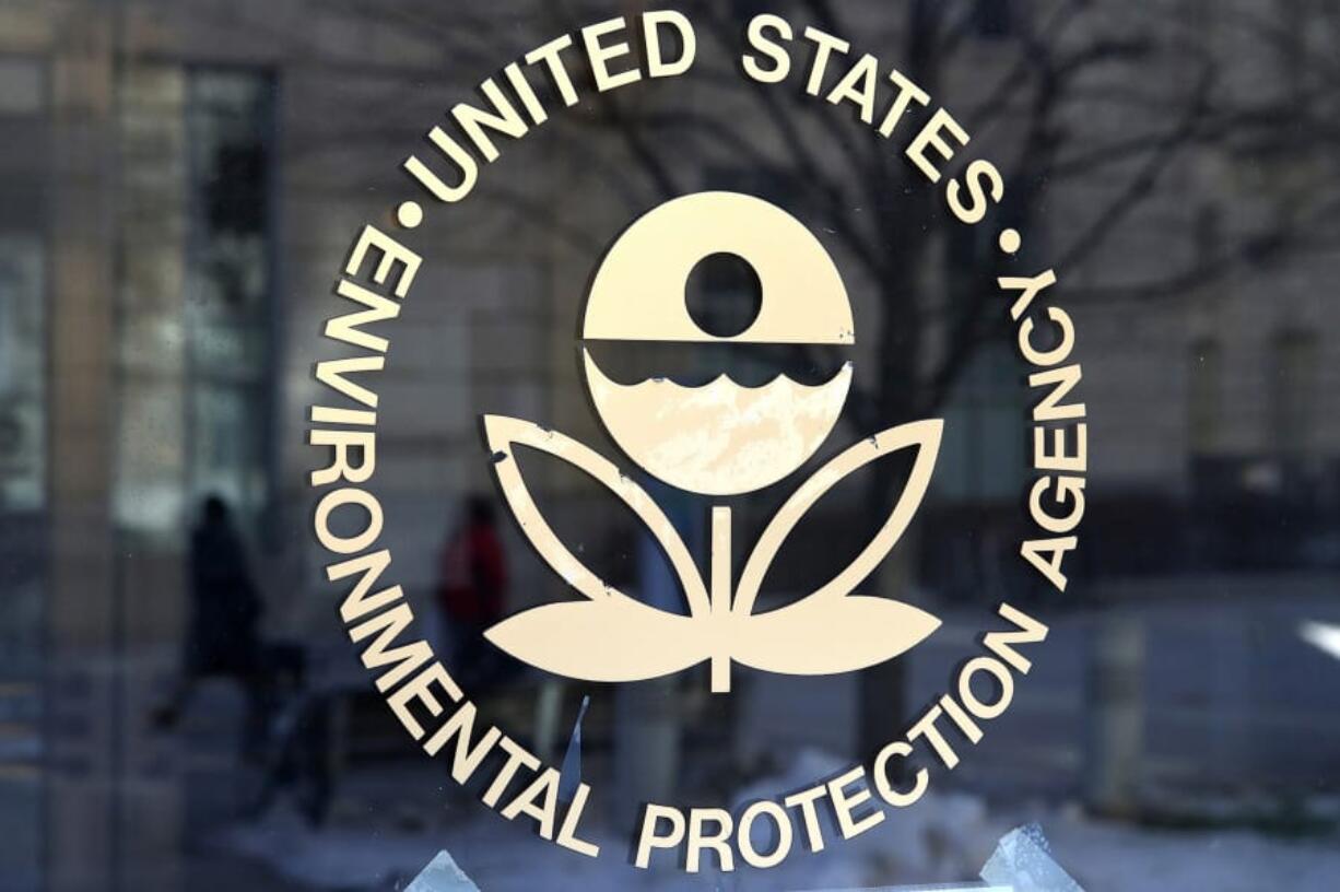 The U.S. Environmental Protection Agency&#039;s logo is displayed on a door at its headquarters in Washington, D.C. The temporary policy relaxing reporting requirements on pollutants, due to coronavirus, will end in August.