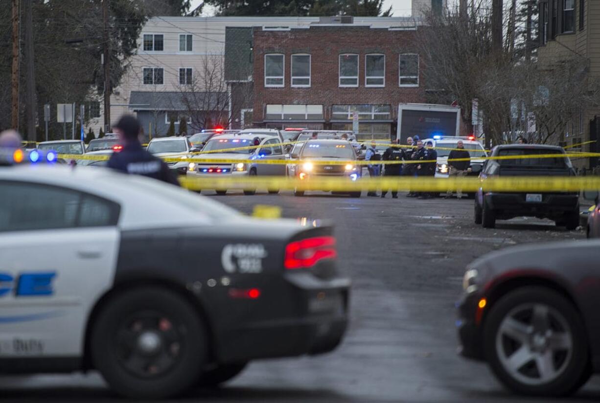 Crime scene tape and police cars are visible at the scene of a police shooting in downtown Vancouver in February 2019.