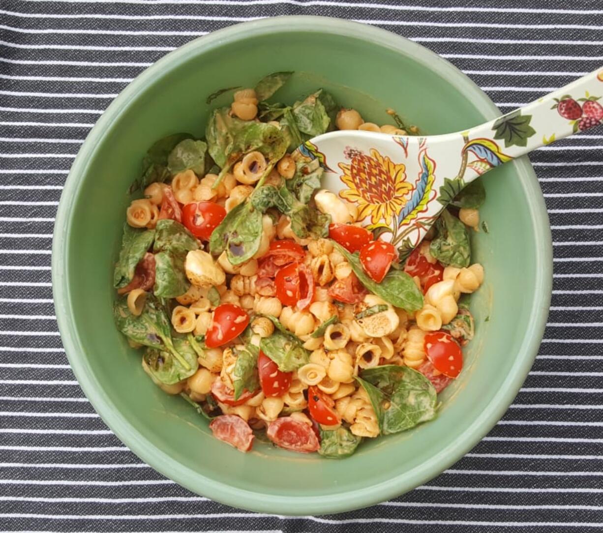 Boxed pasta shells and cheddar cheese form the basis for this caprese salad-inspired dinner with mozzarella, tomatoes and basil. Add pesto for a little zing.