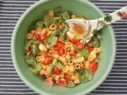 Boxed pasta shells and cheddar cheese form the basis for this caprese salad-inspired dinner with mozzarella, tomatoes and basil. Add pesto for a little zing.