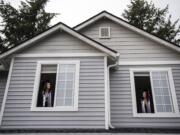 Union High School seniors Lauryn Lopez, left, and her twin sister Ashtyn look out the windows of their Vancouver home.