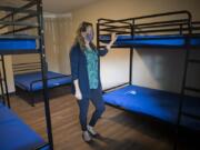 Amy Reynolds, deputy director of Share, looks over one of the newly renovated rooms at Share Orchards Inn. The shelter received new metal bed frames to help prevent bed bugs, which have been an issue in the past.