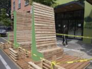 Vancouver resident Natany Reid checks out parklet seating under construction for guests outside The Mighty Bowl in downtown Vancouver on Tuesday morning. The popular restaurant is the first to build outdoor seating of this kind for customers.