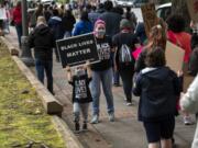 Lacey Meehan and her son Kellan, 4, of Vancouver, join hundreds of people as they come together for a peaceful protest against police brutality outside Clark County Courthouse in Vancouver on June 5, 2020. Lacey said her and her son talked on the way to the rally about how black and brown people are treated differently than white people and how this is unjust.