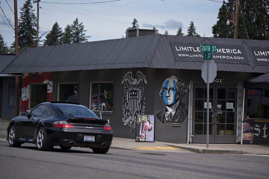 A motorist drives past Limitless America, a firearm retailer in Washougal in June 2020.