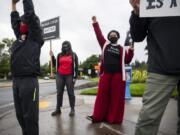 Jack Curtis of Vancouver, 10, left, and Mill Plain Elementary School first grader teachers Corinne Contreras, center, and Carmela Lemon, right, join the Black Lives Matter Rally Day of Action. &quot;(Children) need to know America has a history of injustice,&quot; Lemon said.