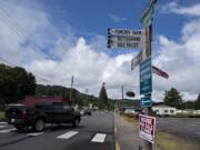 A motorist drives through downtown Yacolt as signs point the way to nearby towns and areas of interest.