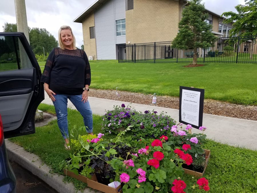 WOODLAND: Woodland High School teacher Shari Conditt picks up plants she ordered at the school&#039;s annual plant sale.