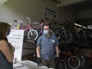 Vancouver resident Bev Warnock, left, talks with shop manager Eric Lien about repair for a bike at Bike Clark County on Wednesday morning. Bike sales have spiked during the COVID-19 pandemic.