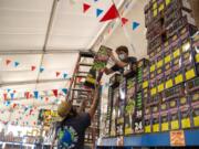 Assistant sales floor managers Cory Pena, left, and Skye Leach set up fireworks at TNT Fireworks Warehouse in Vancouver in June 2020.