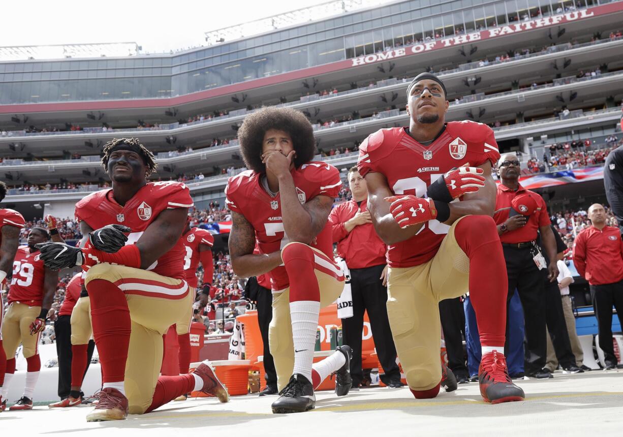 From left, San Francisco 49ers outside linebacker Eli Harold, quarterback Colin Kaepernick and safety Eric Reid kneel during the national anthem before an NFL game in 2016. Nearly four years later, it seems more people are starting to side with Kaepernick’s peaceful protest against police brutality, racial injustice and social inequality and now are calling out those who don’t understand the intent behind his action.