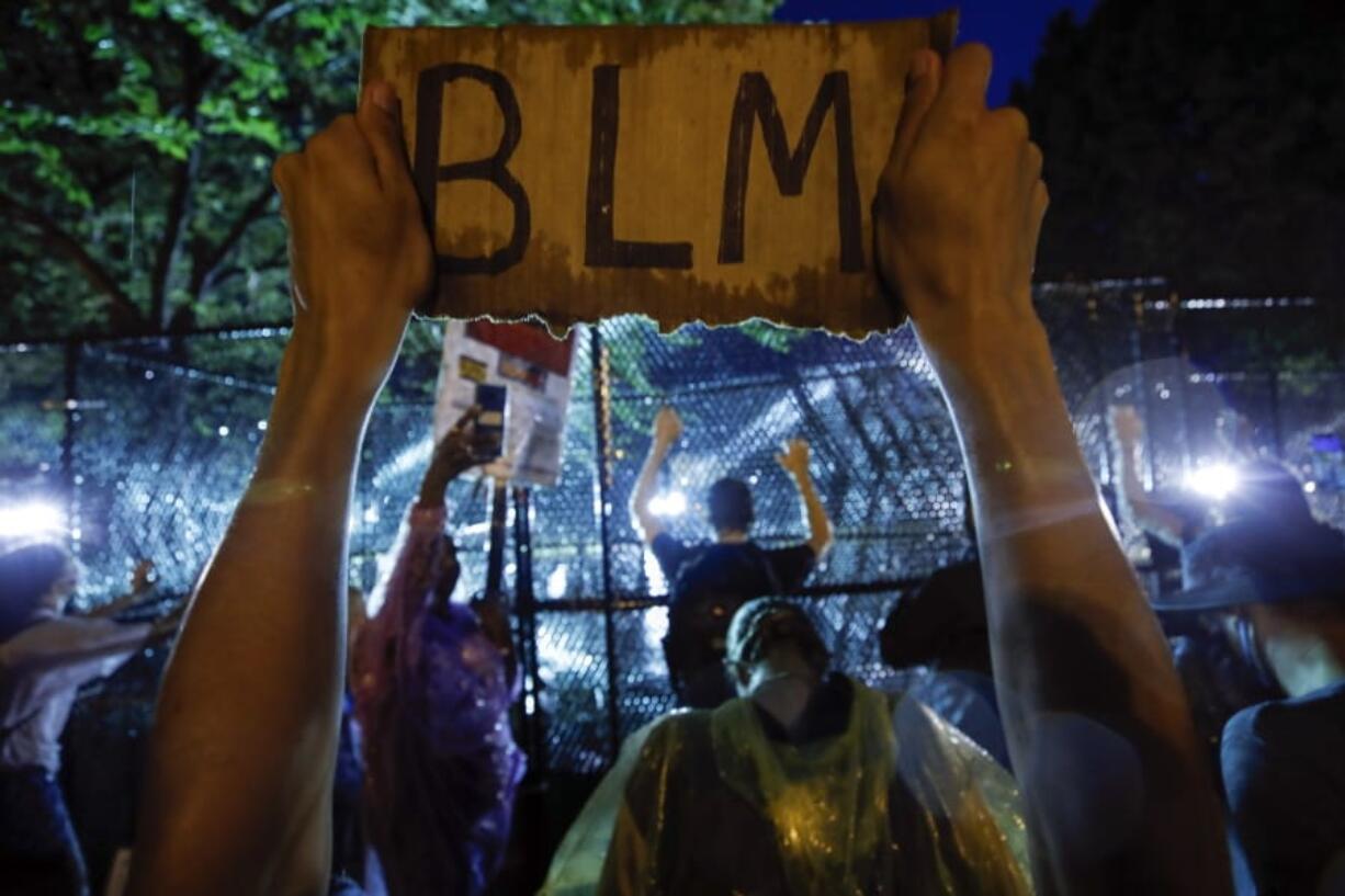 Demonstrators protest Thursday, June 4, 2020, near the White House in Washington, over the death of George Floyd, a black man who was in police custody in Minneapolis. Floyd died after being restrained by Minneapolis police officers.