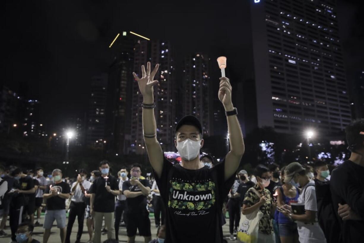 Participants gesture with five fingers, signifying the &quot;Five demands - not one less&quot; during a vigil for the victims of the 1989 Tiananmen Square Massacre at Victoria Park in Causeway Bay, Hong Kong, Thursday, June 4, 2020. China is tightening controls over dissidents while pro-democracy activists in Hong Kong and elsewhere try to mark the 31st anniversary of the crushing of the pro-democracy movement in Beijing&#039;s Tiananmen Square.