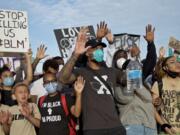 Portland Trail Blazers&#039; Damian Lillard, center, joins other demonstrators in Portland, Ore., during a protest against police brutality and racism, sparked by the death of George Floyd, who died May 25 after being restrained by police in Minneapolis.