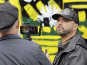 Joey Gibson, right, founder of the far-right group Patriot Prayer, takes part in a livestream video broadcast, inside what has been named the Capitol Hill Occupied Protest zone in Seattle, Monday, June 15, 2020.  (AP Photo/Ted S.