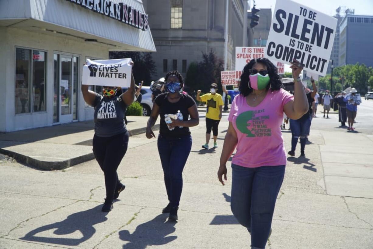 In this Saturday, June 6, 2020 photo provided by The Record, Black Catholics walk from the federal courthouse building in downtown Louisville, Ky., to 12th and Broadway, in the &quot;Black Catholics Unite: Stand For Justice March&quot; which was organized by young adults. Black Catholics across the U.S. hear their church&#039;s leaders once again calling for racial justice, but at this volatile moment they want action as well as words.