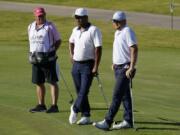 From right, Zac Blair, Harold Varner III and caddie Rick Wynn observe a moment of silence to pay their respects to the memory of George Floyd on the 16th hole during the second round of the Charles Schwab Challenge golf tournament at the Colonial Country Club in Fort Worth, Texas, Friday, June 12, 2020. (AP Photo/David J.