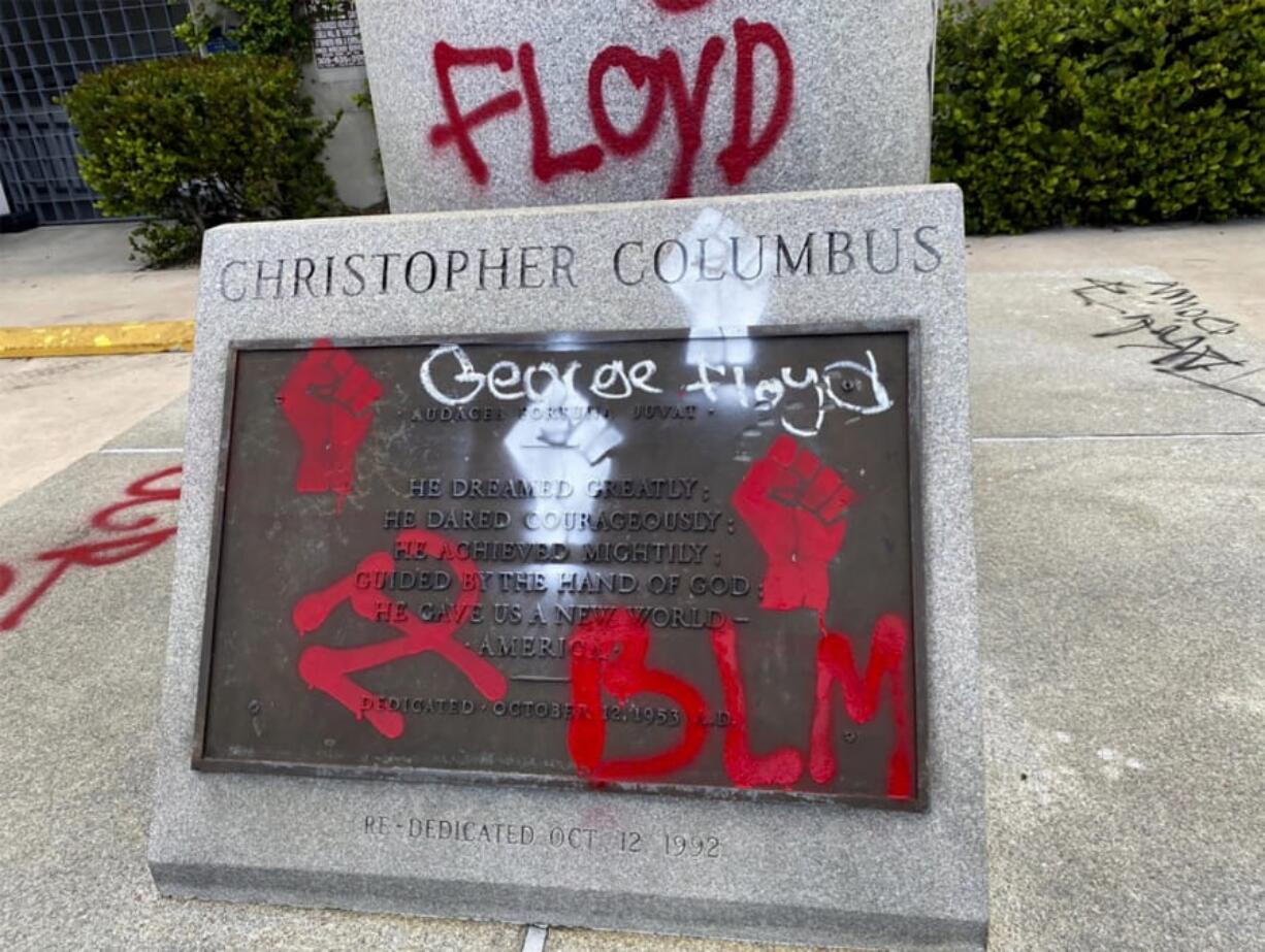 In this June 2020 photo released by the Miami Police Department, the pedestal where a statue of Christopher Columbus stands is seen vandalized in Miami. Miami police said several people were arrested Wednesday, June 10 for vandalizing statues of  Columbus and Juan Ponce de Leon in the city.