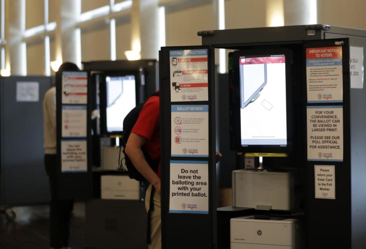 People vote at voting booths in the Georgia&#039;s primary election at Park Tavern on Tuesday, June 9, 2020, in Atlanta.