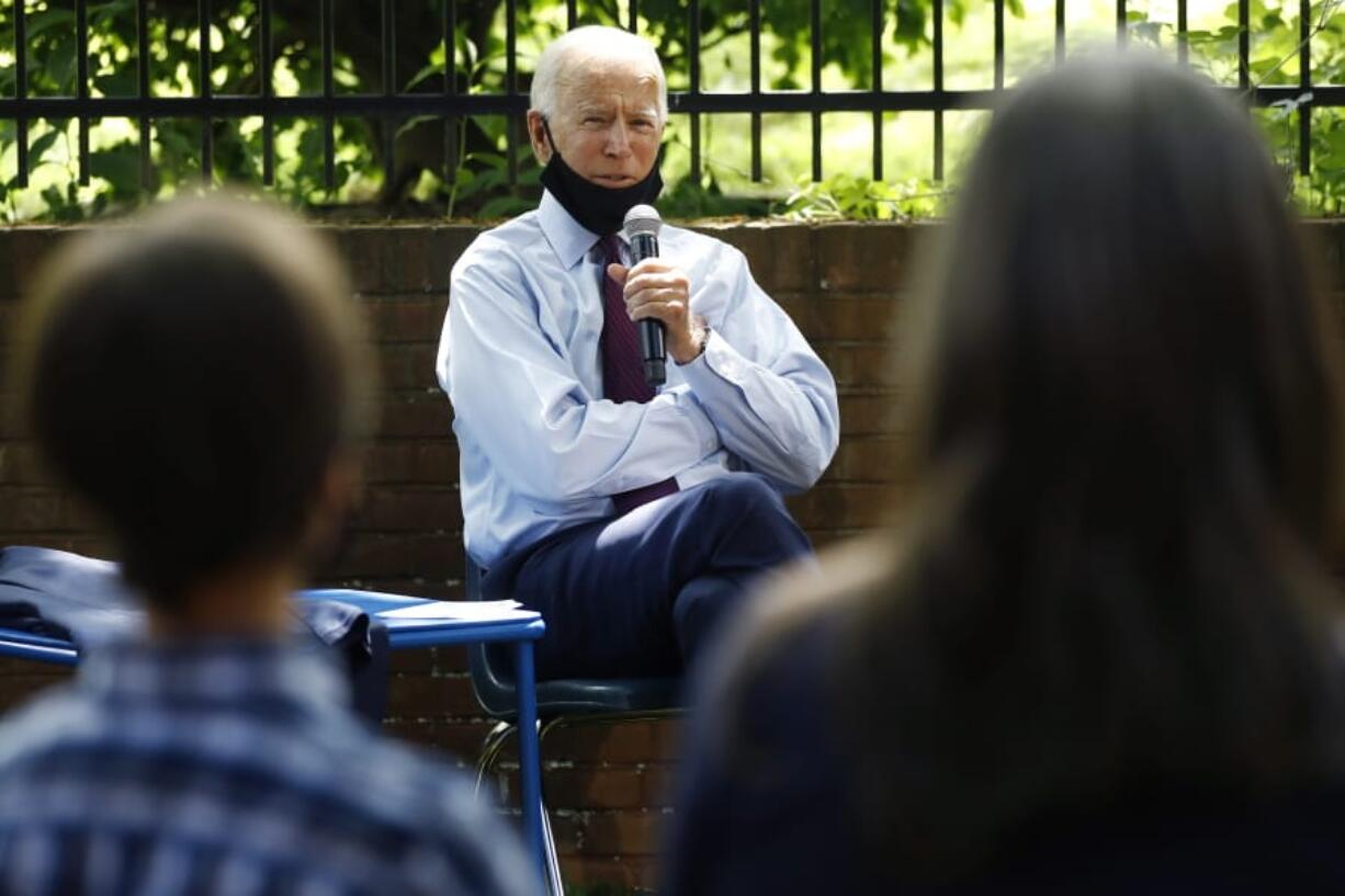 Democratic presidential candidate, former Vice President Joe Biden, center, speaks to Stacie Ritter, right, and her son, Jan, during a meeting with families who have benefited from the Affordable Care Act, Thursday, June 25, 2020, in Lancaster, Pa.