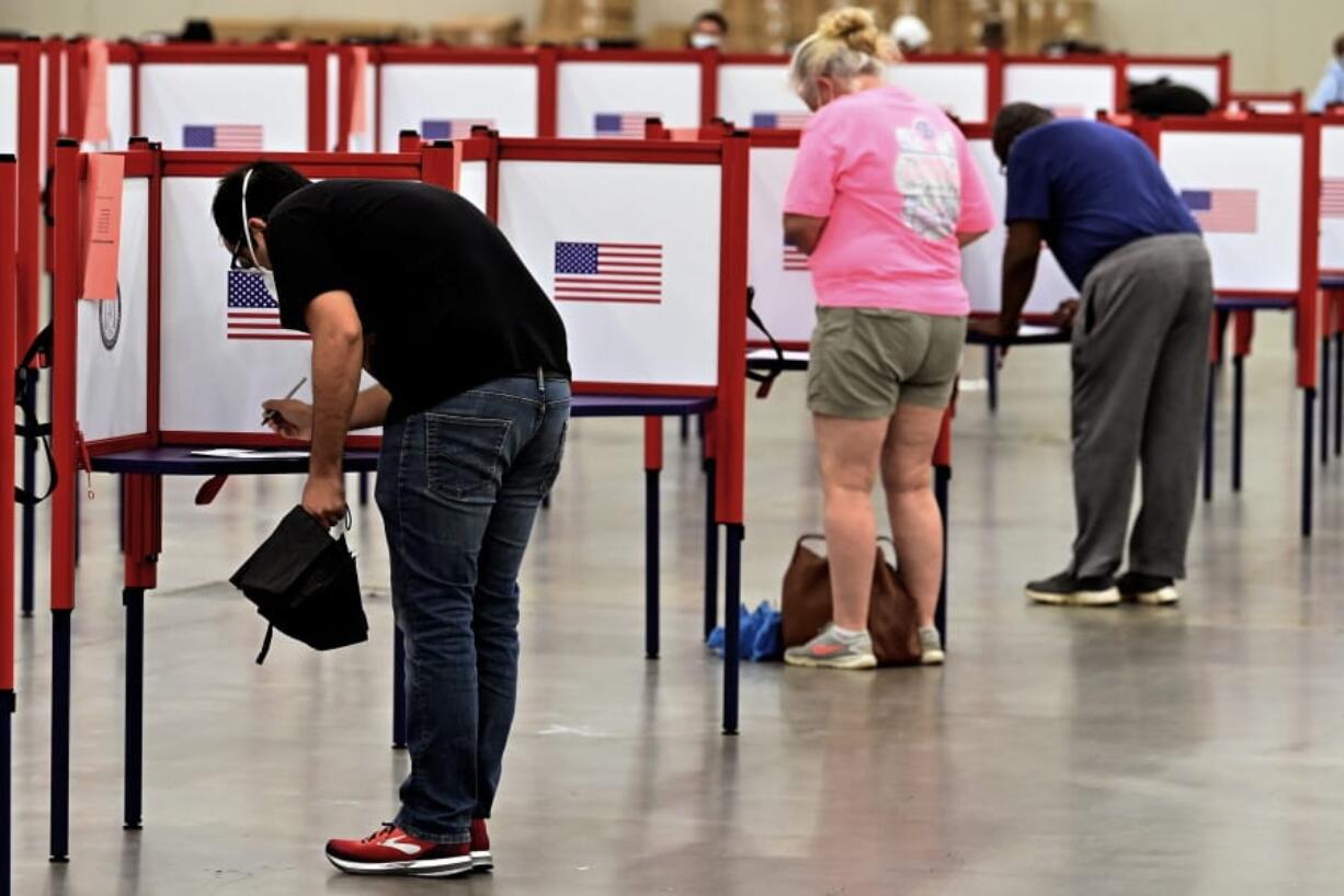 Voters fill out their ballots during in person voting in the Kentucky Primary at the Kentucky Exposition Center in Louisville, Ky., Tuesday, June 23, 2020. In an attempt to prevent the spread of the coronavirus, neighborhood precincts were closed and voters that didn&#039;t cast mail in ballots were directed to one central polling location. (AP Photo/Timothy D.