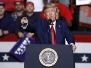 FILE - In this Friday, Feb. 28, 2020, file photo, President Donald Trump speaks during a campaign rally, in North Charleston, S.C. Trump is looking to reverse a decline in his political fortunes by returning to the format that has so often energized himself and his base: a raucous, no-holds-barred rally before thousands of ardent supporters. Trump understands the stakes and is pushing ahead despite pleas from some health officials in Oklahoma to delay a rally in Tulsa on Saturday, June 20 until the region has a better handle on the coronavirus.