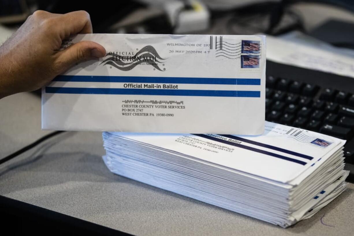 In this May 28, 2020, photo, Dave Turnier processes mail-in ballots at at the Chester County Voter Services office in West Chester, Pa., prior to the primary election. Tuesday&#039;s primary elections in seven states are both significant elections and big tests of campaigning during the age of coronavirus.