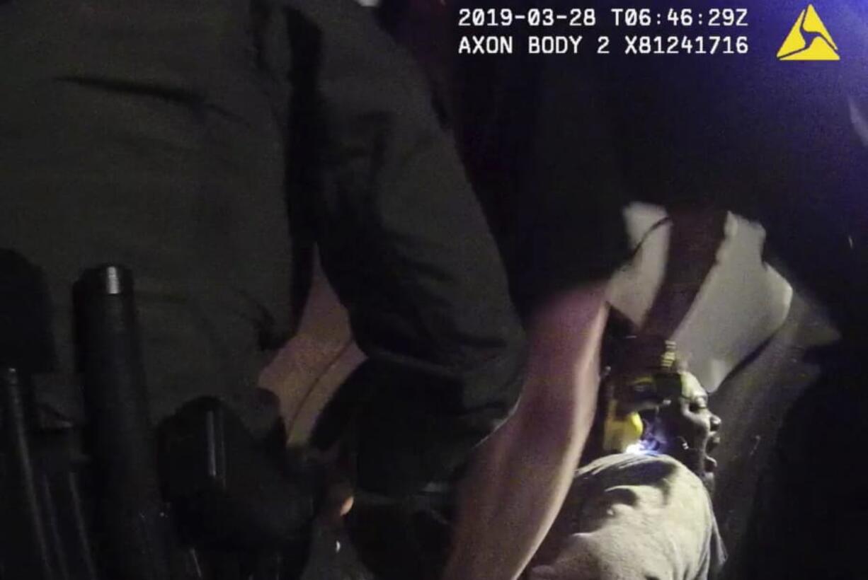 In this image made from a March 28, 2019, body-worn camera video provided by the Austin Police Department in Texas, Williamson County deputies hold down Javier Ambler as one of them uses a Taser on Ambler&#039;s back during his arrest in Austin, Texas. The black man died in custody in 2019 after sheriff&#039;s deputies repeatedly used stun guns on him, despite his pleas that he was sick and couldn&#039;t breathe, according a report published Monday, June 8, 2020, by the Austin American-Statesman and KVUE-TV. The video was made on the camera worn by an Austin police officer who also showed up at the scene as Williamson County deputies were making the arrest.