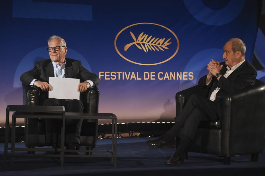 Cannes Festival director Thierry Fremaux, left, festival president Pierre Lescure, sit during the presentation of the festival lineup, in an empty cinema Wednesday, June 3, 2020 in Paris. The Cannes Film Festival was canceled due to the pandemic but it announced the films that would have played at the French Riviera festival.