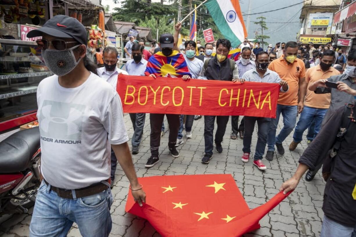 Exile Tibetans and local Indians participate in a protest against the Chinese government in Dharmsala, India, Friday, June 19, 2020. India said Thursday it was using diplomatic channels with China to de-escalate a military standoff in a remote Himalayan border region where 20 Indian soldiers were killed this week.