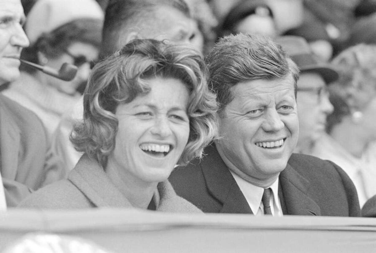 FILE - In this April 10, 1961, file photo, President John F. Kennedy and his sister, Jean Kennedy Smith, watch an opening day baseball game at Griffith Stadium in Washington.  Smith, the youngest sister and last surviving sibling of President John F. Kennedy, died at 92, her daughter Kym confirmed to the New York Times.