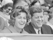 FILE - In this April 10, 1961, file photo, President John F. Kennedy and his sister, Jean Kennedy Smith, watch an opening day baseball game at Griffith Stadium in Washington.  Smith, the youngest sister and last surviving sibling of President John F. Kennedy, died at 92, her daughter Kym confirmed to the New York Times.