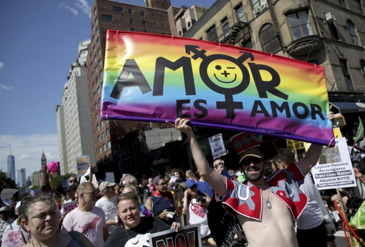 FILE - In this June 30, 2019, file photo, marchers participate in the Queer Liberation March in New York. This year&#039;s Pride events were supposed to be a blowout as LGBTQ people the world over marked the 50th anniversary of the first parade to celebrate what were then the initial small steps in their ability to live openly, and to advocate for bigger victories. Now, Pride is largely taking a backseat, having been driven to the internet by the coronavirus pandemic and now by calls for racial equality that were renewed by the killing of George Floyd in Minneapolis at the hands of police.