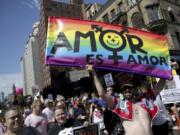 FILE - In this June 30, 2019, file photo, marchers participate in the Queer Liberation March in New York. This year&#039;s Pride events were supposed to be a blowout as LGBTQ people the world over marked the 50th anniversary of the first parade to celebrate what were then the initial small steps in their ability to live openly, and to advocate for bigger victories. Now, Pride is largely taking a backseat, having been driven to the internet by the coronavirus pandemic and now by calls for racial equality that were renewed by the killing of George Floyd in Minneapolis at the hands of police.