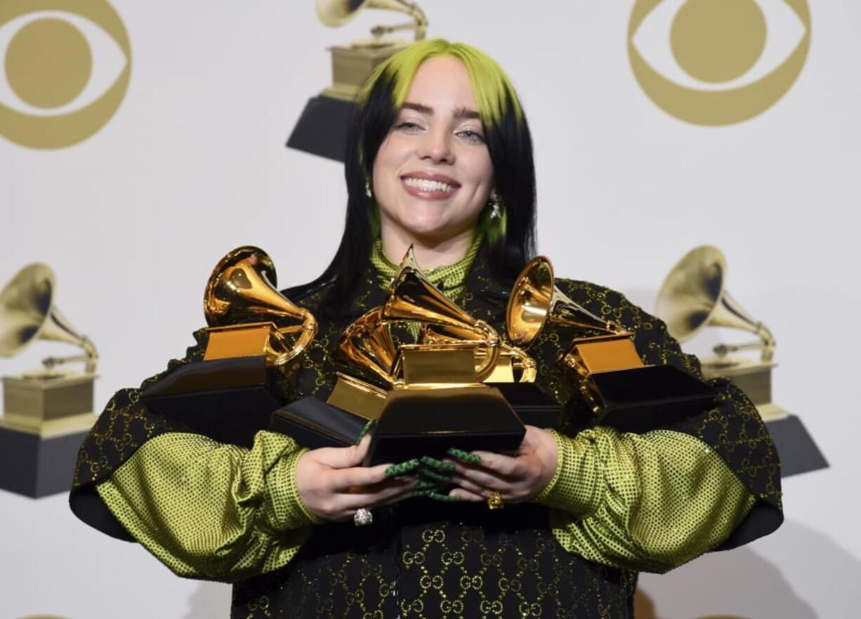 FILE - In this Jan. 26, 2020 file photo, Billie Eilish poses in the press room with the awards for best album and best pop vocal album for &quot;We All Fall Asleep, Where Do We Go?&quot;, best song and record for &quot;Bad Guy&quot; and best new artist at the 62nd annual Grammy Awards in Los Angeles. The Recording Academy is making changes to several Grammy Awards categories, including the often-debated best new artist title, as well as having nomination review committee members sign disclosure forms to prevent conflicts of interest.