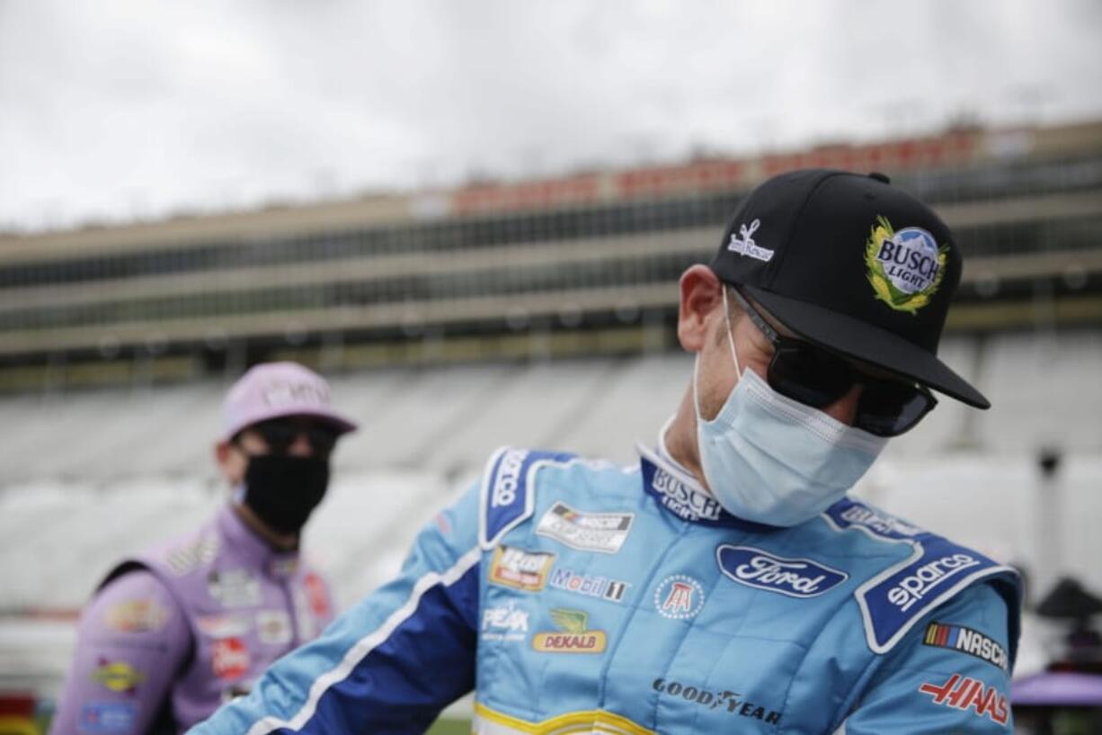 Kyle Busch, left, and Clint Bowyer, right, laugh on pit row before a NASCAR Cup Series auto race at Atlanta Motor Speedway on Sunday, June 7, 2020, in Hampton, Ga.