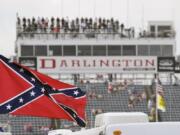 FILE - In this Sept. 5, 2015, file photo, a Confederate flag flies in the infield before a NASCAR Xfinity auto race at Darlington Raceway in Darlington, S.C. Bubba Wallace, the only African-American driver in the top tier of NASCAR, calls for a ban on the Confederate flag in the sport that is deeply rooted in the South.