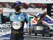 Kevin Harvick celebrates in the winners circle after winning the NASCAR Cup Series auto race at Pocono Raceway, Saturday, June 27, 2020, in Long Pond, Pa.