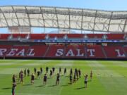 FILE - In this Sept. 12, 2014 file photo, members of the U.S. Women&#039;s National team warm up during practice at Rio Tinto Stadium in Sandy, Utah. Pro soccer returns to the U.S. next month when the National Women&#039;s Soccer League starts a 25-game tournament in a pair of stadiums in Utah that will be kept clear of fans to protect players from the coronavirus. Players from the nine teams will train and live at two Salt Lake City-area hotels, the league announced Wednesday, May 27, 2020.