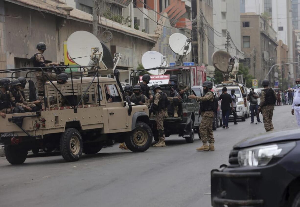 Security personnel surround the Stock Exchange Building in Karachi, Pakistan, Monday, June 29, 2020. Gunmen have attacked the stock exchange in the Pakistani city of Karachi on Monday. Special police forces deployed to the scene of the attack and in a swift operation secured the building.