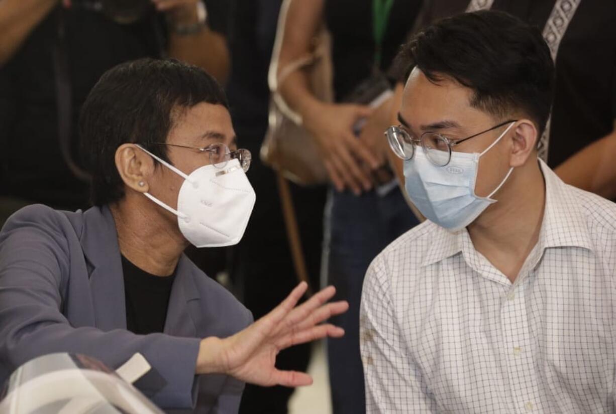 Rappler CEO and Executive Editor Maria Ressa, left, talks with former Rappler reporter Reynaldo Santos Jr., right, during a press conference in Manila, Philippines on Monday June 15, 2020. Ressa, an award-winning journalist critical of the Philippine president, her online news site Rappler Inc. and Santos were convicted of libel and sentenced to jail Monday in a decision called a major blow to press freedom in an Asian bastion of democracy.