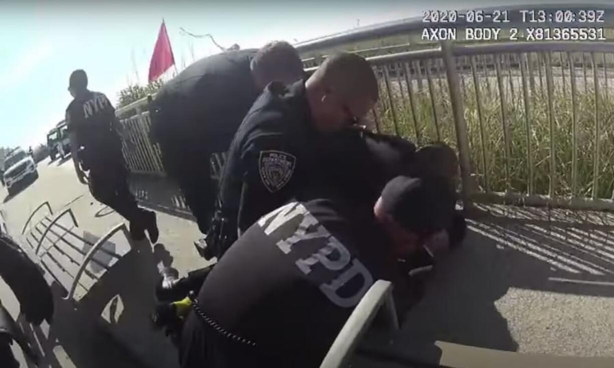 In this photo taken from police body cam video, New York Police officers arrest a man on a boardwalk Sunday, June 21, 2020, in New York. New York City Police Commissioner Dermot Shea says a police officer was quickly suspended without pay after putting his arm around the man&#039;s neck because we are living in &quot;unprecedented times.&quot; Shea announced the suspension on Sunday just hours after the officer used what the commissioner called &quot;an apparent chokehold&quot; during a confrontation on a boardwalk in the Rockaway section of Queens.