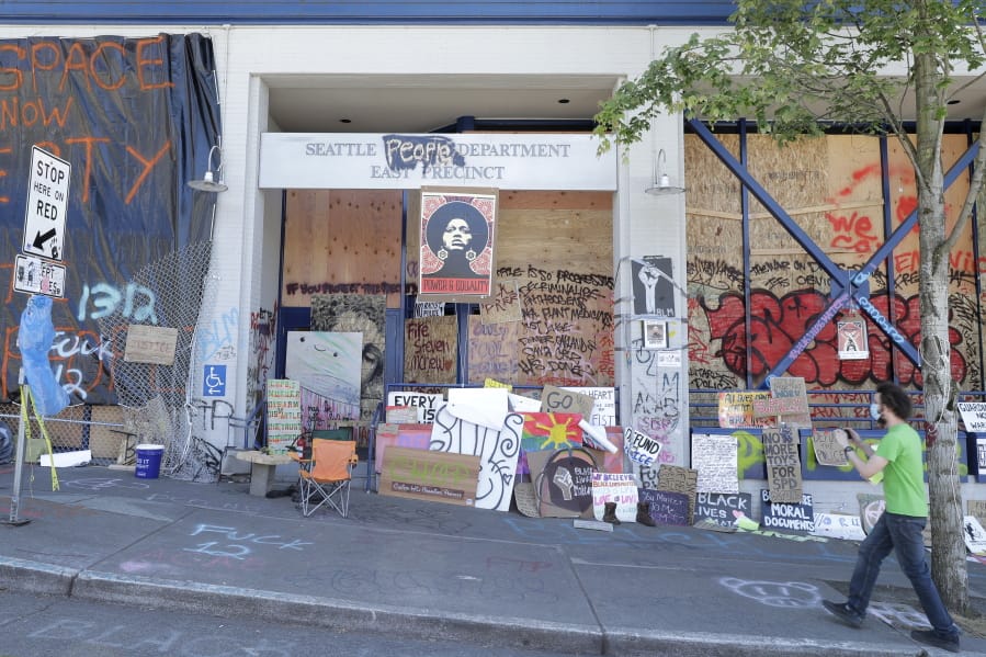 A person takes a photo of the Seattle Police East Precinct building, Monday, June 22, 2020, inside what has been named the Capitol Hill Occupied Protest zone in Seattle. For the second time in less than 48 hours, there was a shooting near the &quot;CHOP&quot; area that has been occupied by protesters after Seattle Police pulled back from several blocks of the city&#039;s Capitol Hill neighborhood near the Police Department&#039;s East Precinct building. (AP Photo/Ted S.