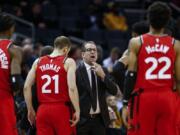 Toronto coach Nick Nurse, center, and the Raptors have an NBA championship to defend, a very long stay at the Disney complex awaiting them and plenty of unanswered questions on how the restart of the season will work.