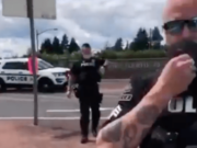 A screen grab from a video posted to Facebook shows Ridgefield police officers talking to protester John Tudor. Tudor was cited for disorderly conduct.