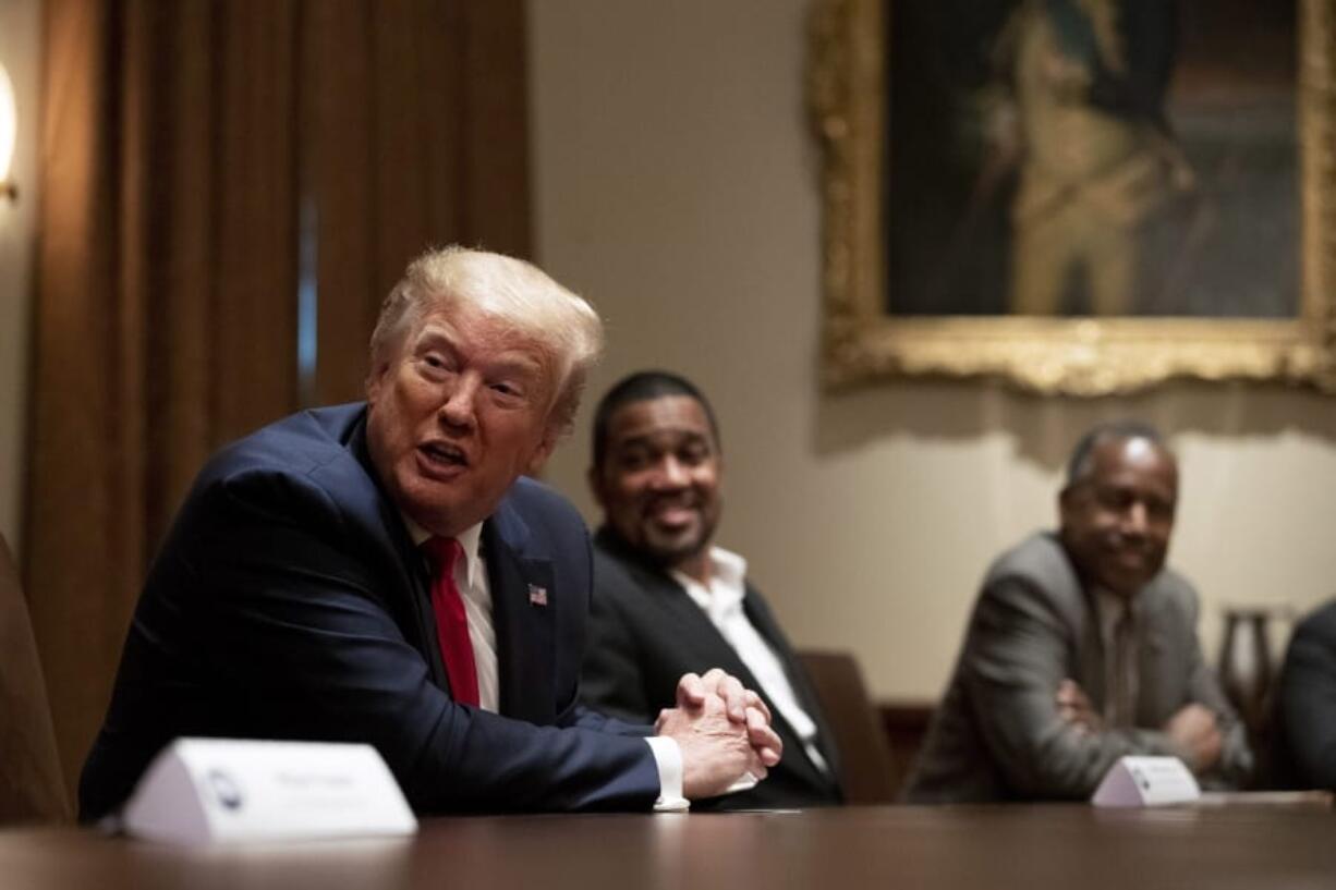 President Donald Trump speaks during a roundtable discussion with African-American supporters in the Cabinet Room of the White House, Wednesday, June 10, 2020, in Washington. Seated alongside Trump are Pastor Darrell Scott and Housing and Urban Development Secretary Ben Carson.