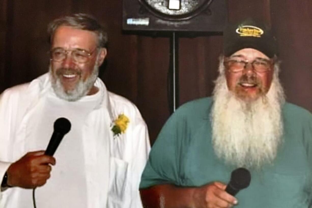 In this Aug. 8, 2012, photo provided by Meghan Boyd Carrier, her father, Cleon Boyd, left, and his twin brother Leon Boyd perform during her wedding in Readsboro, Vt. Cleon died from the coronavirus on April 3, 2020. Leon also died from the coronavirus less than a week later.