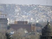 FILE - This Dec. 25, 2013, filer, photo shows a general view of the U.S. Embassy in Kabul, Afghanistan after it was hit by rocket fire in Kabul, Afghanistan. The U.S. State Department says Saturday, June 20, 2020 that COVID-19 infections have been reported at its embassy in the Afghan capital and the staff who are affected include diplomats, contractors and locally employed staff.