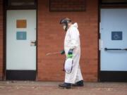 A worker for Leicester City Council disinfects public toilets in Leicester, England, Monday June 29, 2020. The central England city of Leicester is waiting to find out if lockdown restrictions will be extended as a result of a spike in coronavirus infections.